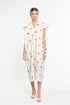 Woman wearing a white dress with colorful floral patterns on a white background