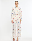 Woman wearing a white floral pajama set on a white background