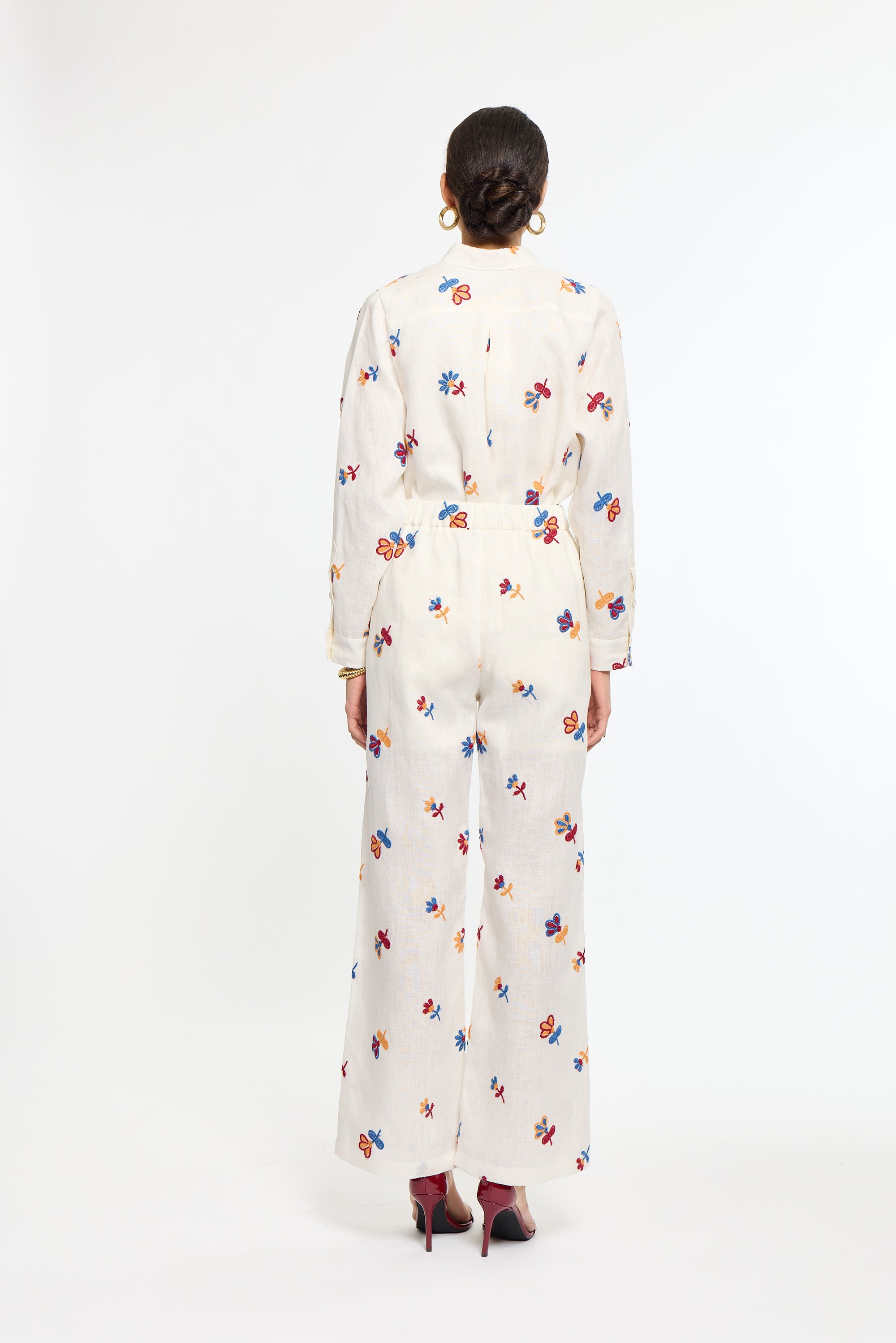 Person wearing a white floral dress on a white background