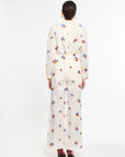 Person wearing a white floral dress on a white background