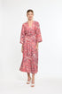 Woman wearing a red and white patterned dress on a white background