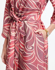Red and white patterned dress with a belt on a white background