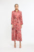 Woman wearing a red and white patterned dress on a white background