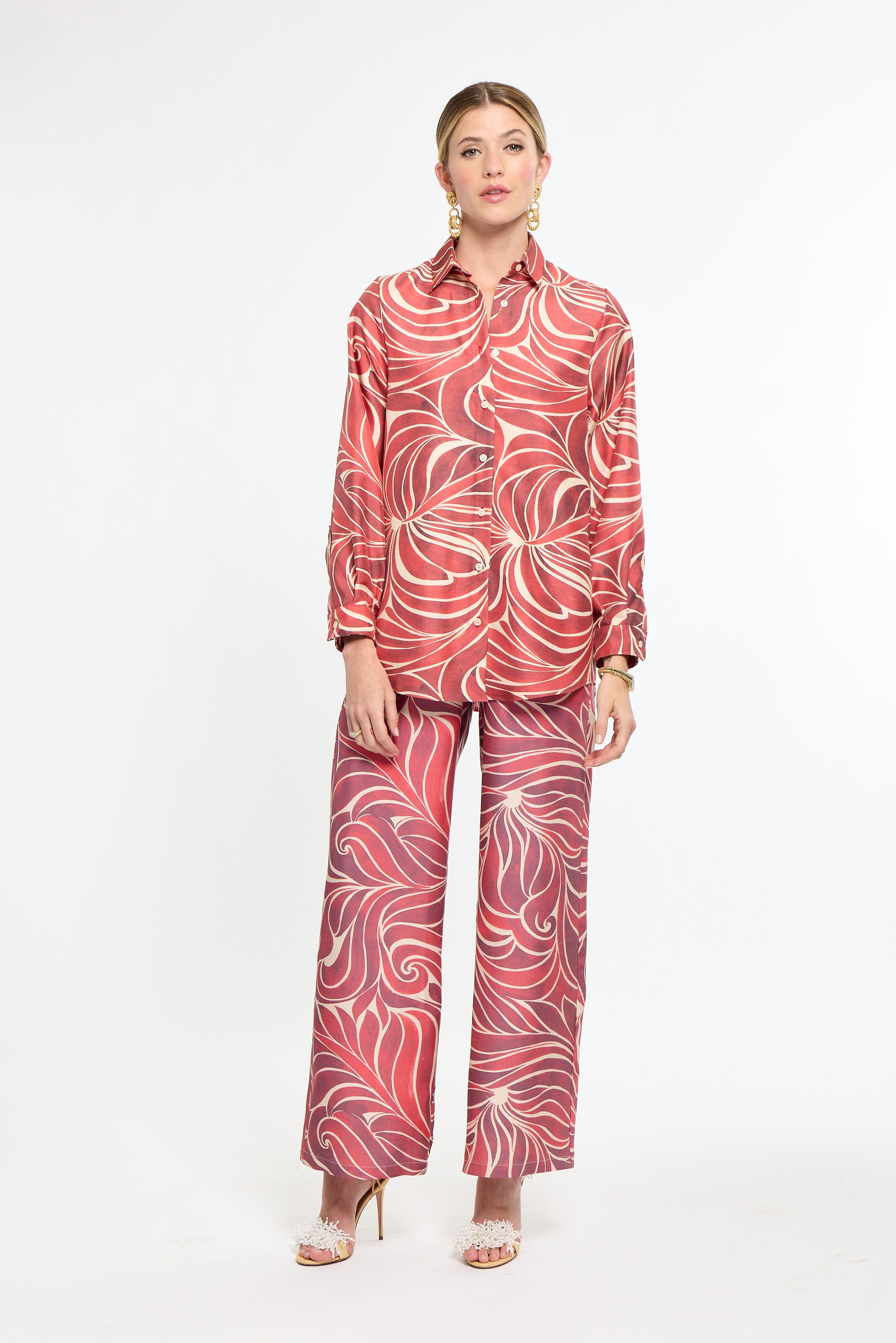 Woman wearing a red and white patterned outfit on a white background