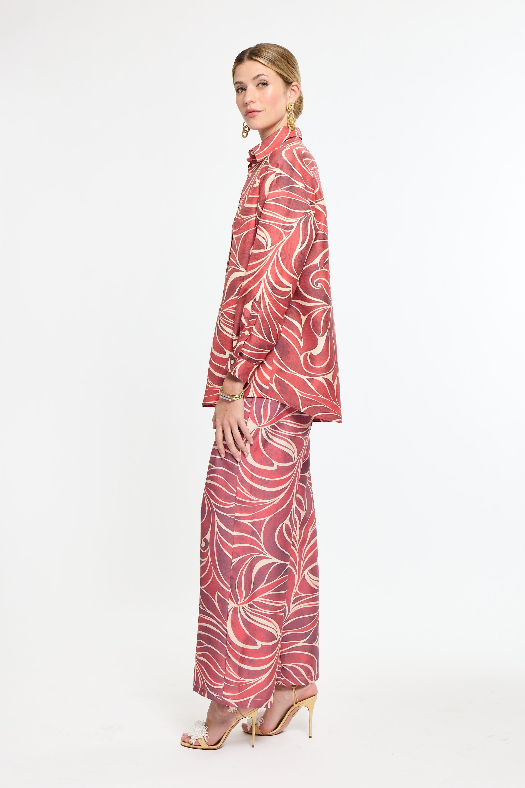Woman wearing a red and white patterned outfit on a white background