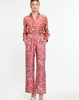 Woman wearing a red patterned outfit on a white background