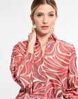Woman wearing a red and white patterned dress on a white background