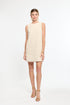 Woman wearing a beige dress on a white background