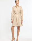 Woman wearing a beige striped dress on a white background