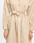 Beige and white striped dress with a belt on a white background