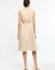 Woman wearing a beige and white striped dress on a white background
