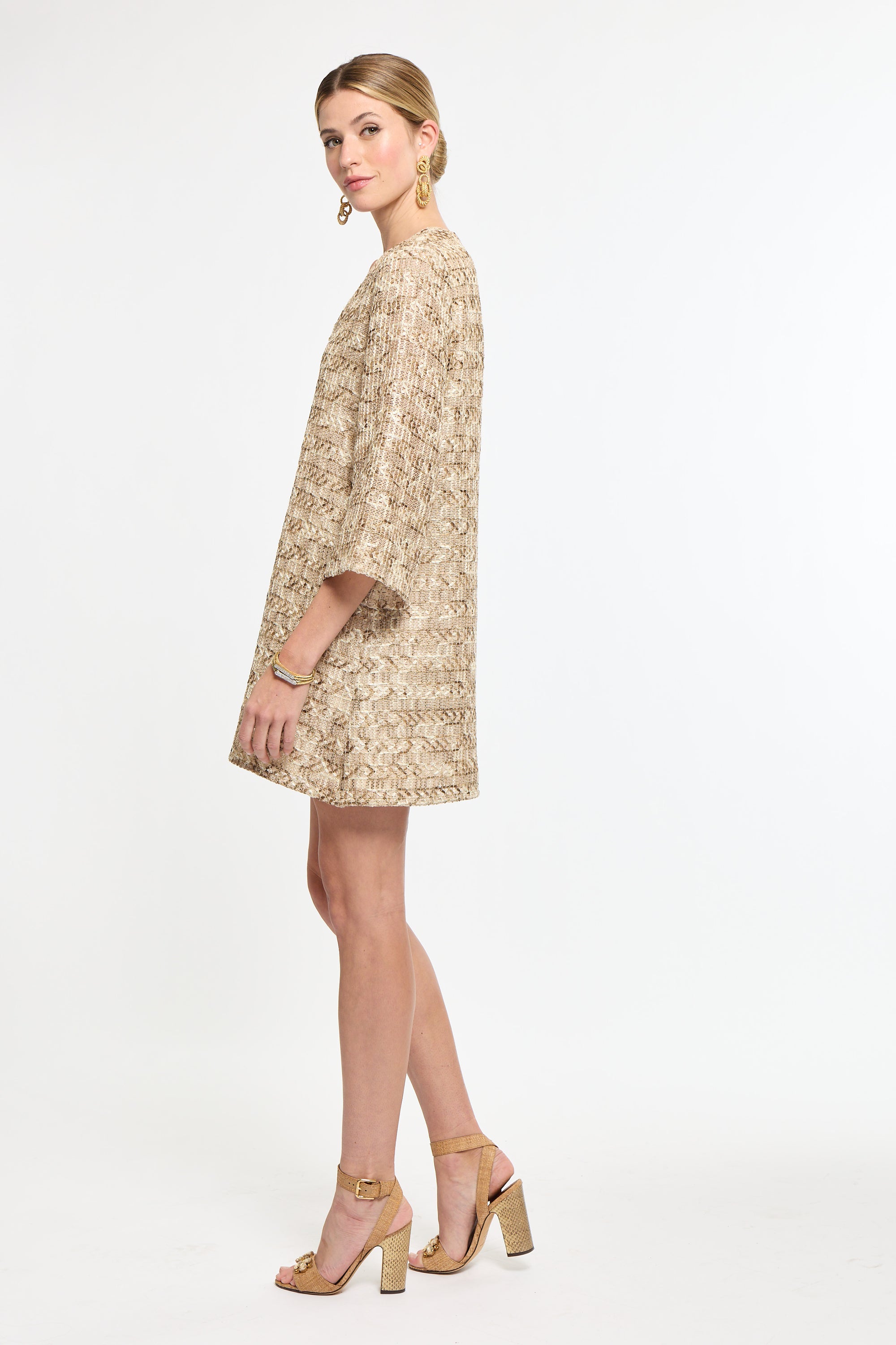 Woman wearing a beige floral dress on a white background
