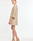 Woman wearing a beige floral dress on a white background