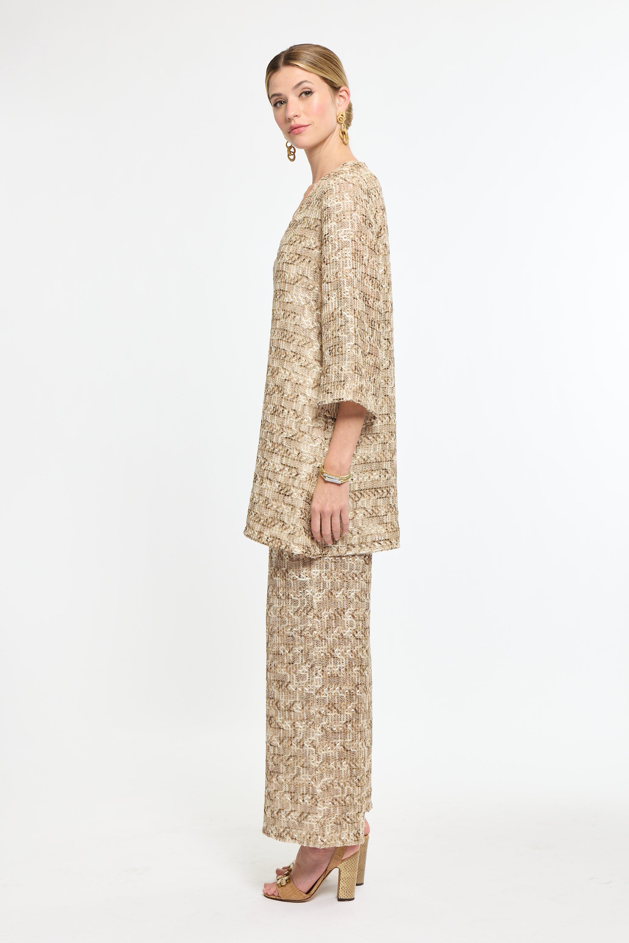 Woman wearing a beige floral outfit on a white background