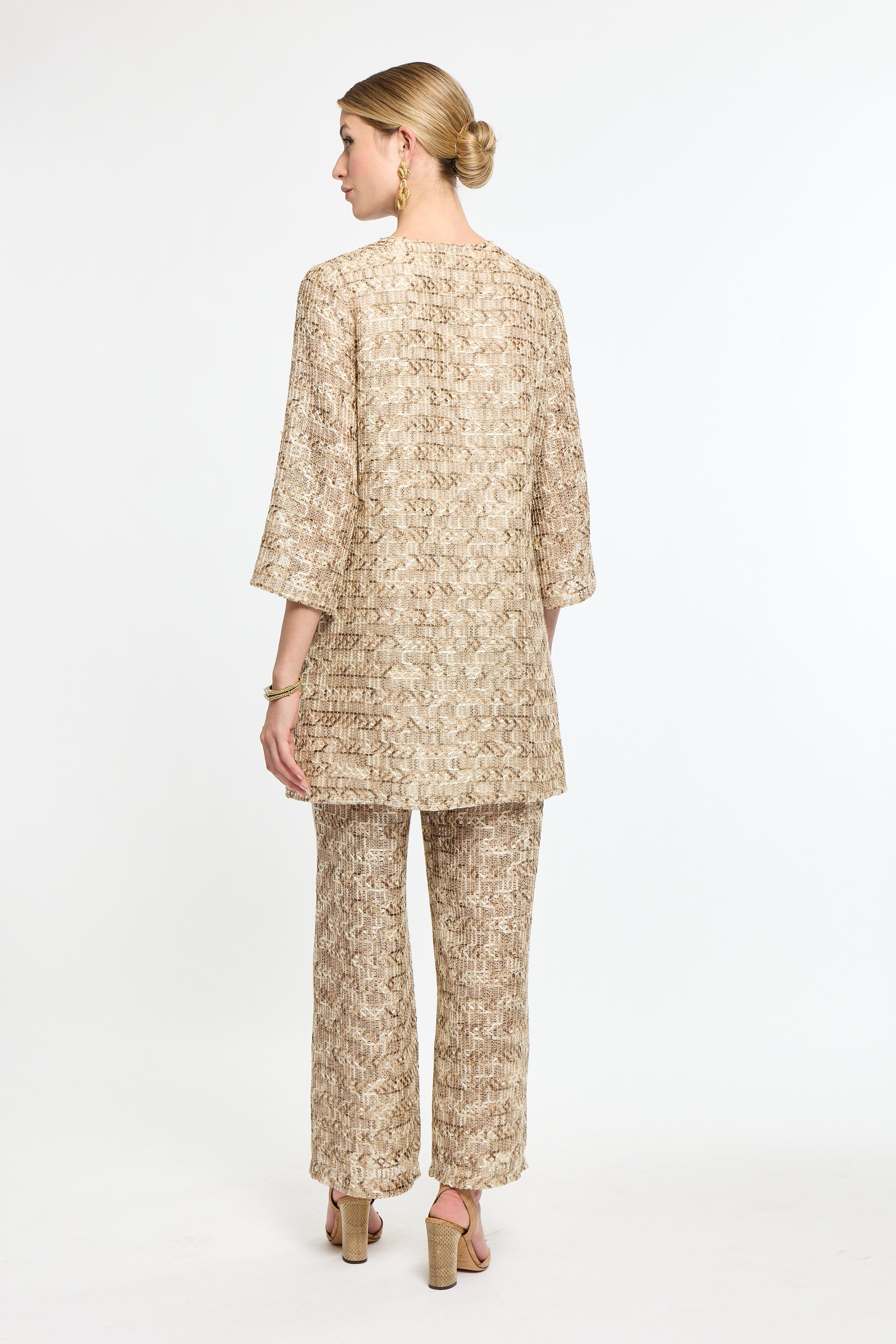 Woman wearing a beige floral outfit on a white background