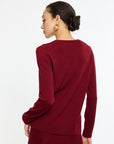Woman wearing a burgundy sweater on a white background
