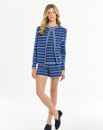 Woman wearing a blue striped outfit on a white background