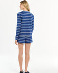 Woman wearing a blue and white striped dress on a white background