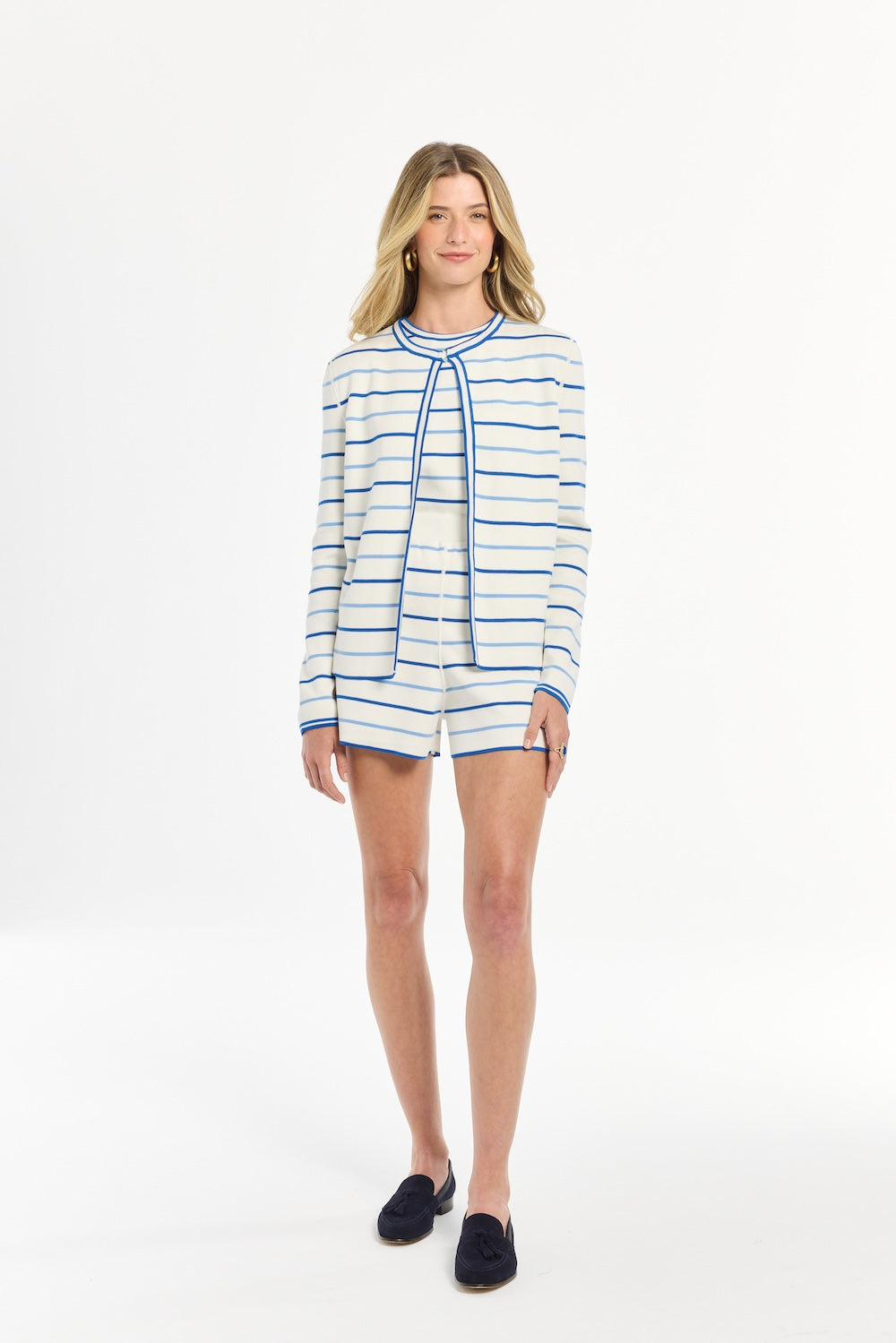 Woman wearing a striped shirt and shorts on a white background