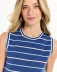 Woman wearing a blue and white striped sleeveless top on a white background