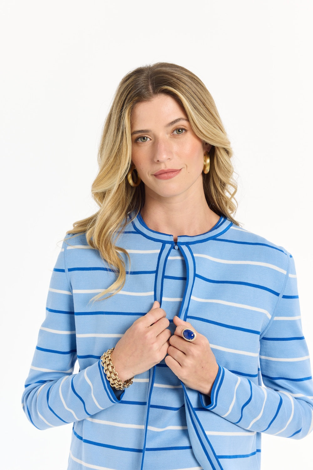 Woman wearing a blue and white striped sweater on a white background