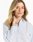 Woman wearing a blue and white striped shirt on a white background