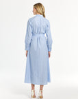 Woman modeling a light blue dress striped on a white background
