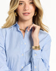 Woman wearing a blue striped dress with a white background