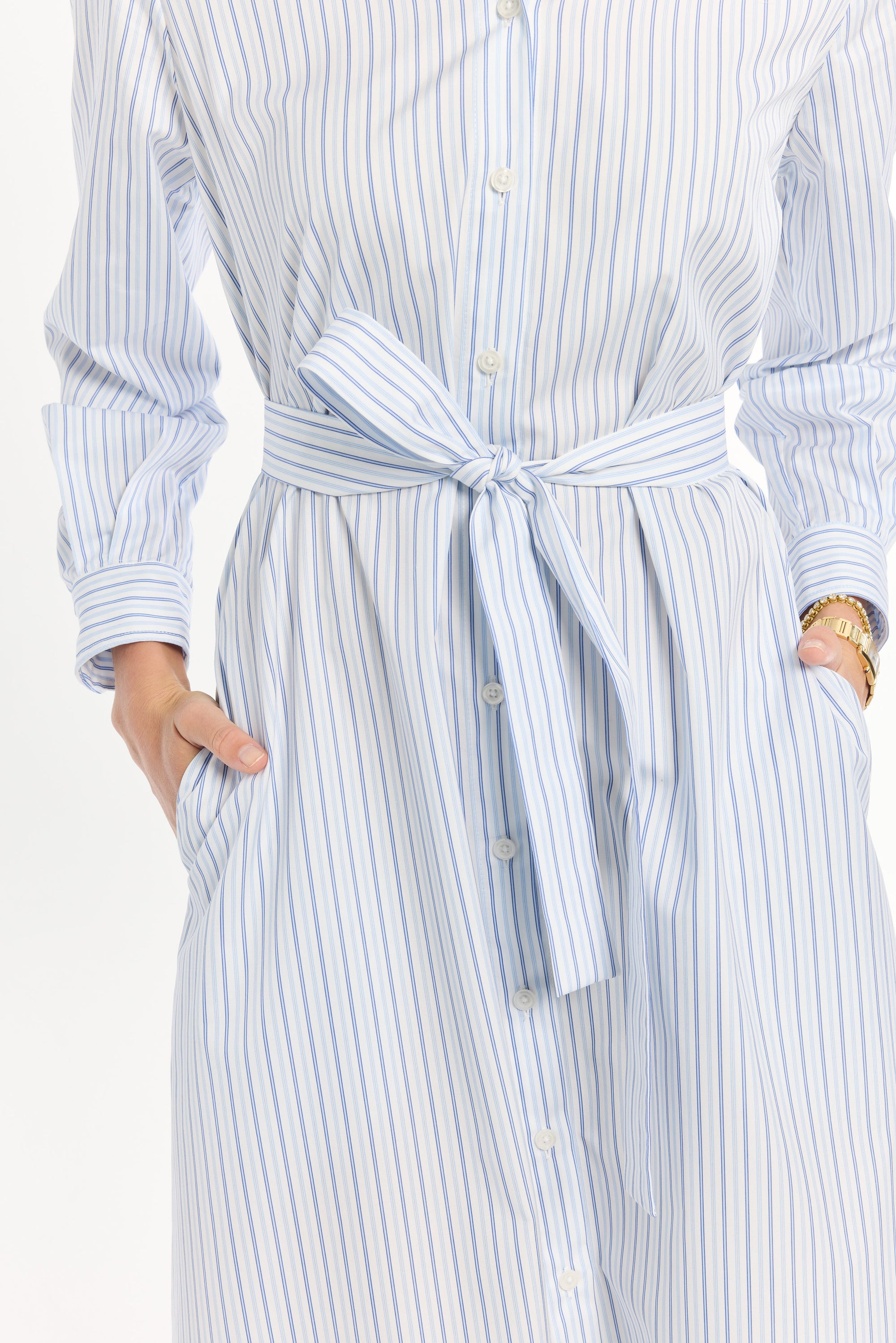 Blue and white striped dress with a belt on a white background
