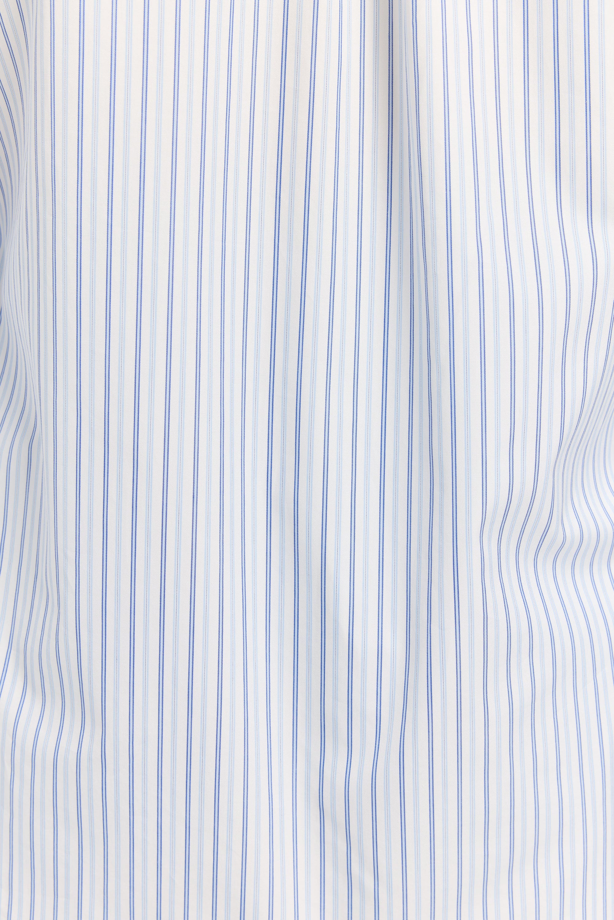 Close-up of a white fabric with blue vertical stripes