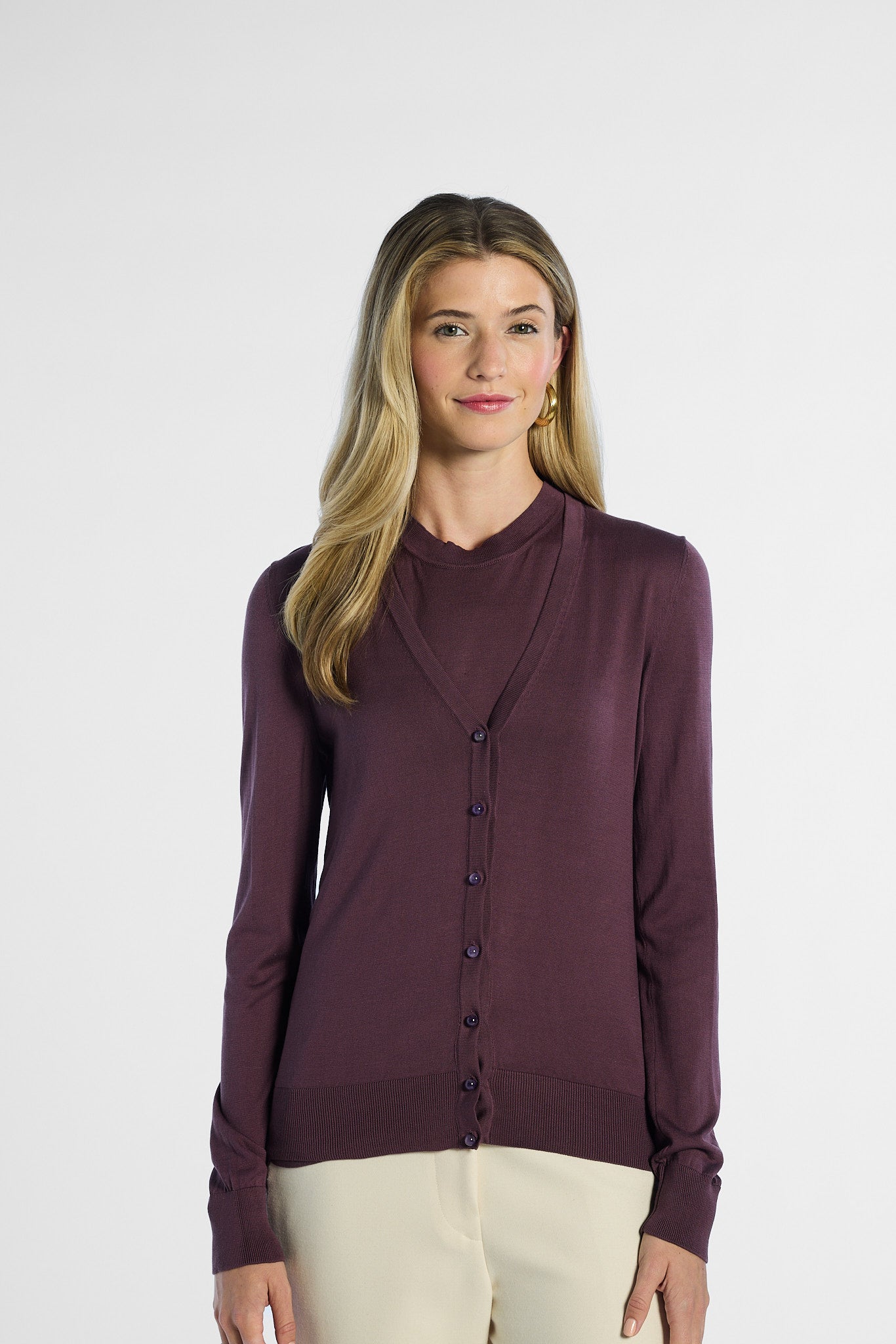 Woman wearing a purple cardigan on a white background