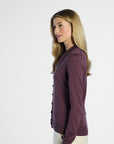 Side profile of a woman wearing a purple cardigan on a white background
