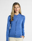 Woman wearing a blue silk cardigan on a white background