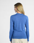 Back profile of a woman wearing a blue sweater on a white background