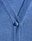Close-up of a blue cardigan with a Blue Spot Jasper button 