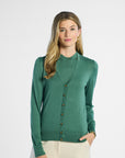 Woman wearing a green silk cardigan on a white background