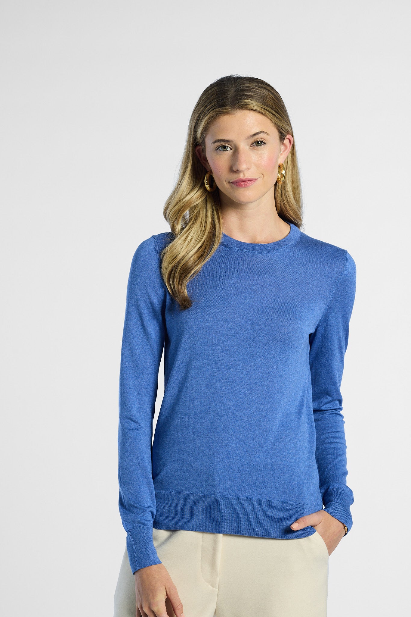 Woman wearing a blue sweater on a white background