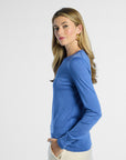 side profile of a woman wearing a blue sweater on a white background