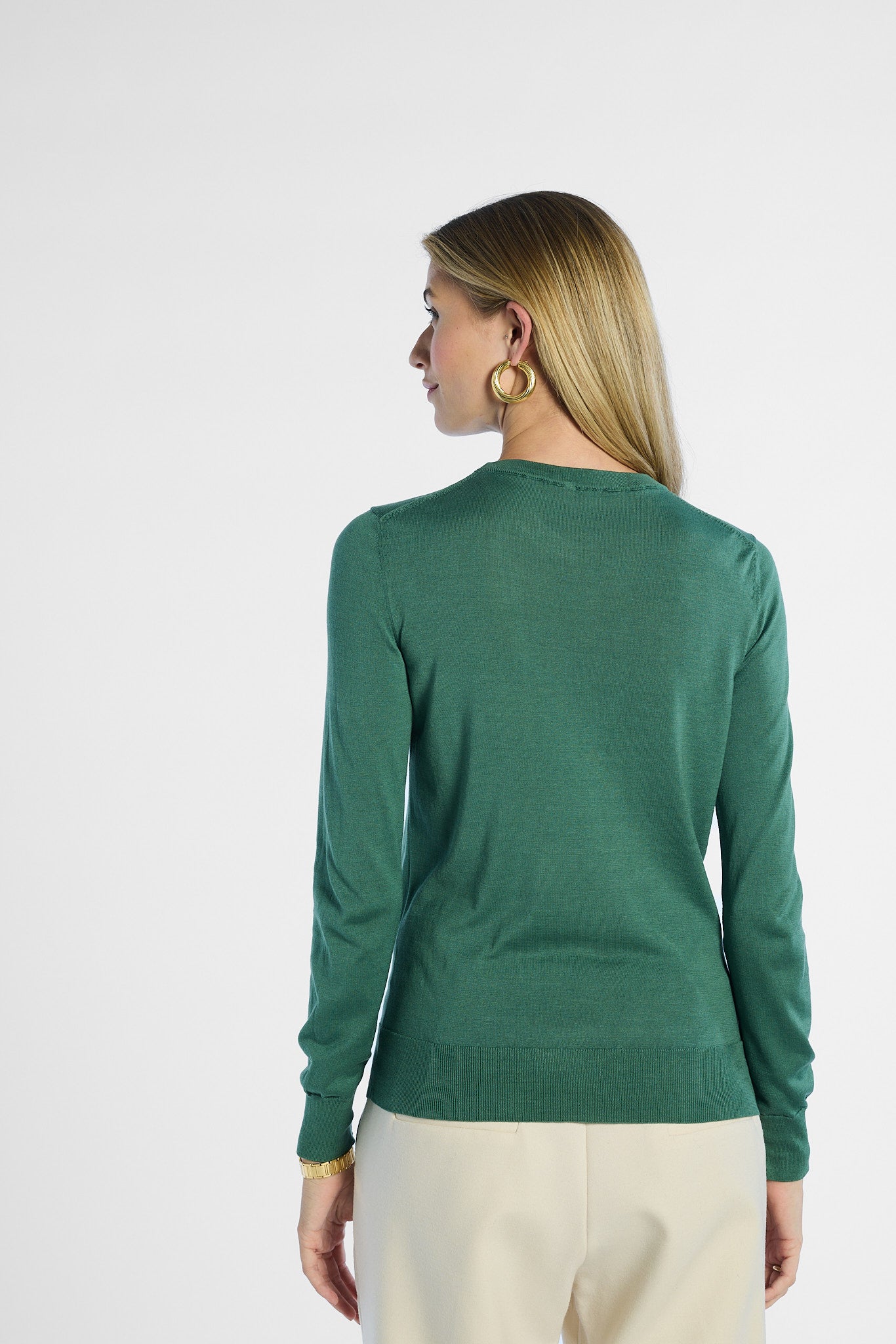 Woman wearing a green sweater on a white background