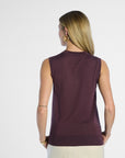 back profile of a woman wearing a sleeveless purple silk top on a white background