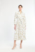 Woman wearing a white dress with gold pattern on a white background