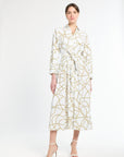Woman wearing a white dress with gold pattern on a white background