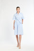 Woman wearing a light blue dress on a white background