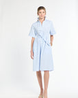 Woman wearing a light blue dress on a white background