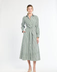 Woman wearing a green and white striped dress on a white background