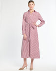 Woman wearing a red and white striped dress on a white background