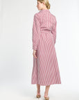 Woman wearing a pink and white striped dress on a white background