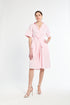 Woman wearing a pink dress on a white background