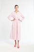 Woman wearing a pink dress on a white background