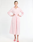 Woman wearing a pink dress on a white background